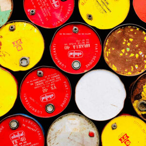 red and yellow lids on crude oil barrels