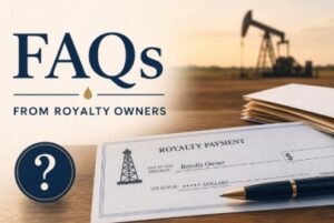 royalty check on a desk with an oil rig in the background